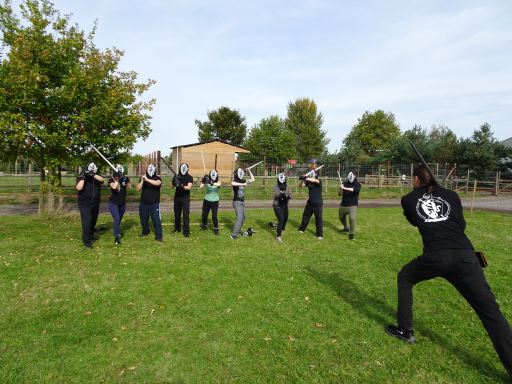 The Marshal of the Academy of Steel demonstrating a stance while participants in a taster session copy him.